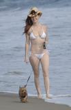 Phoebe Price in her bikini with her dog on the beach in Malibu